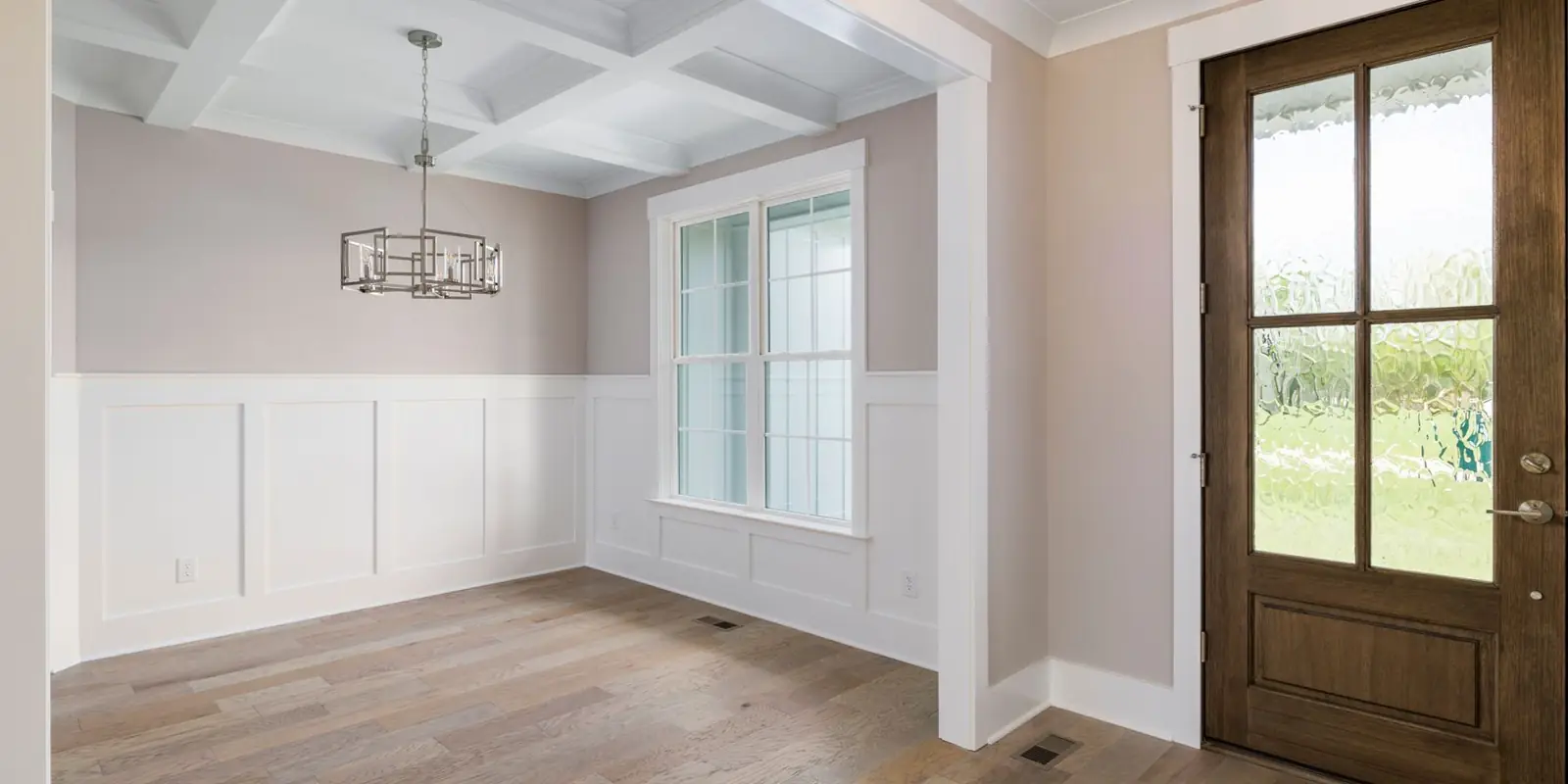 A room with new baseboard, wainscot and door trim
