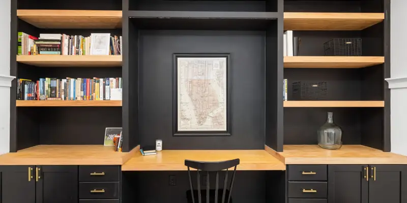 Built-in shelves and a desk along one wall