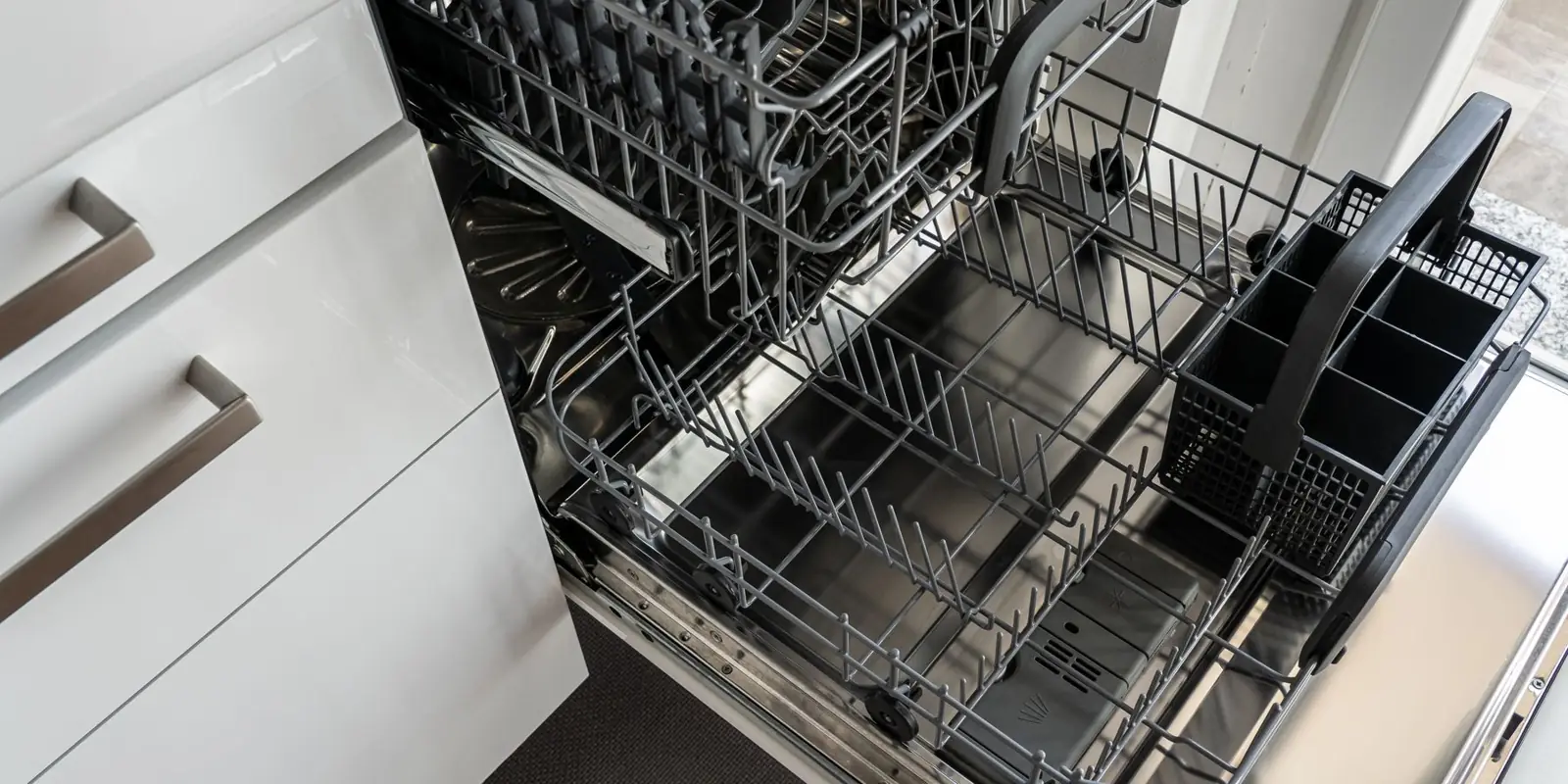 An open dishwasher with its racks pulled out