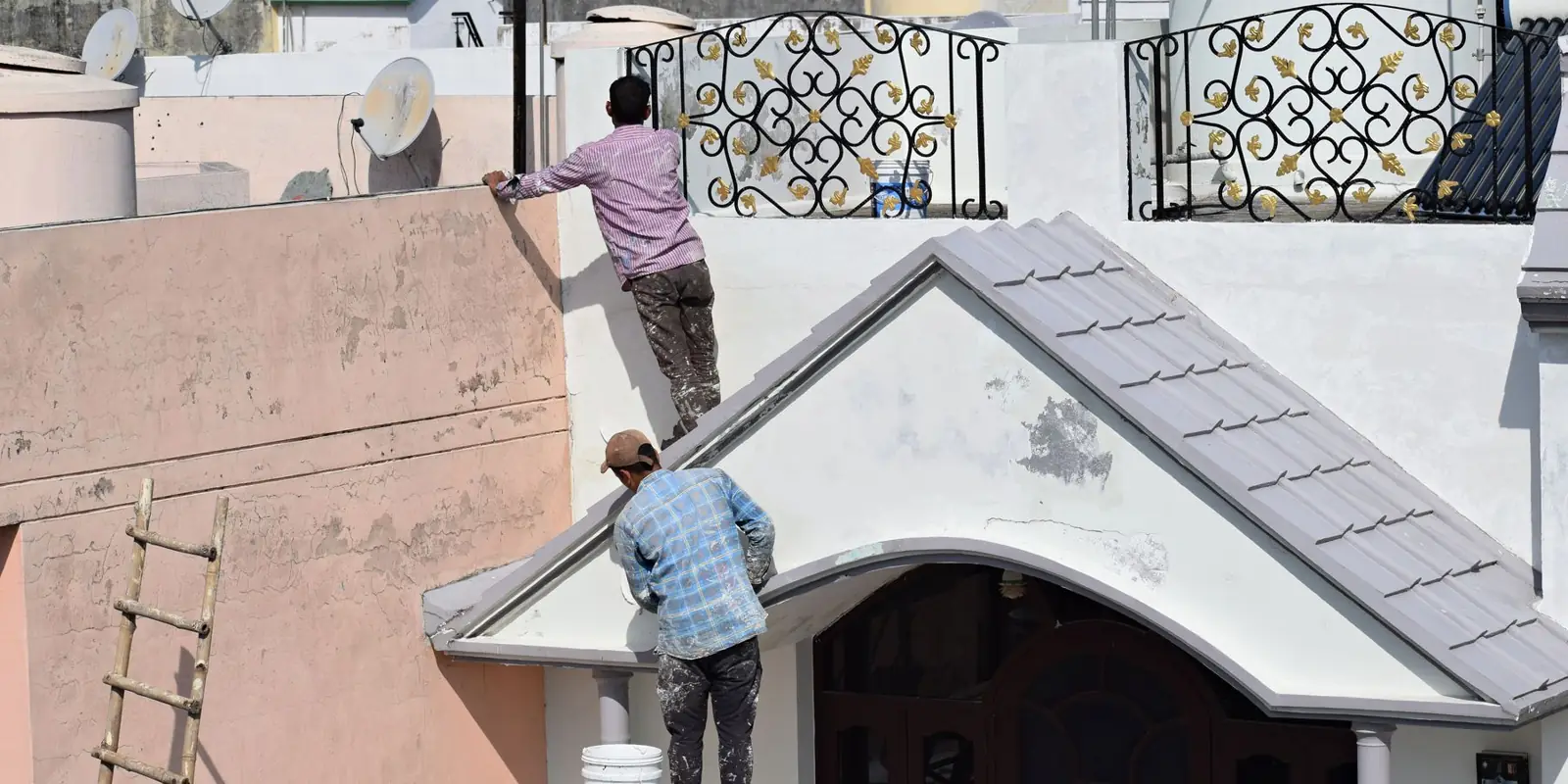 Painters working on the outside of a house