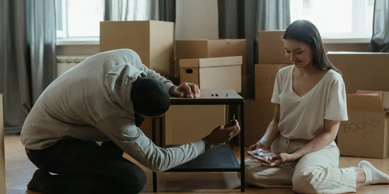 Two people putting together a table