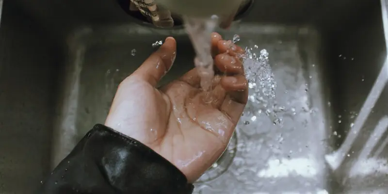Water running into a stainless kitchen sink