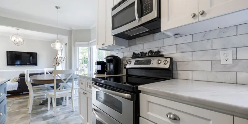 A microwave mounted over a kitchen range