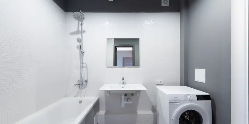 A washing machine set up beside a tub